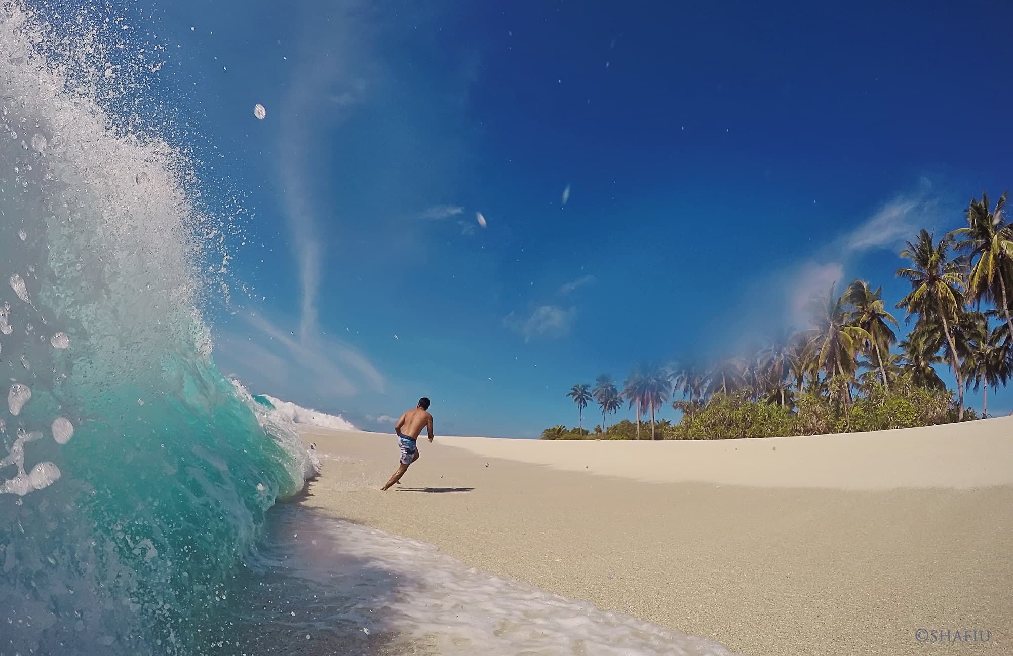 Surfer riding a wave in Fuvahmulah
